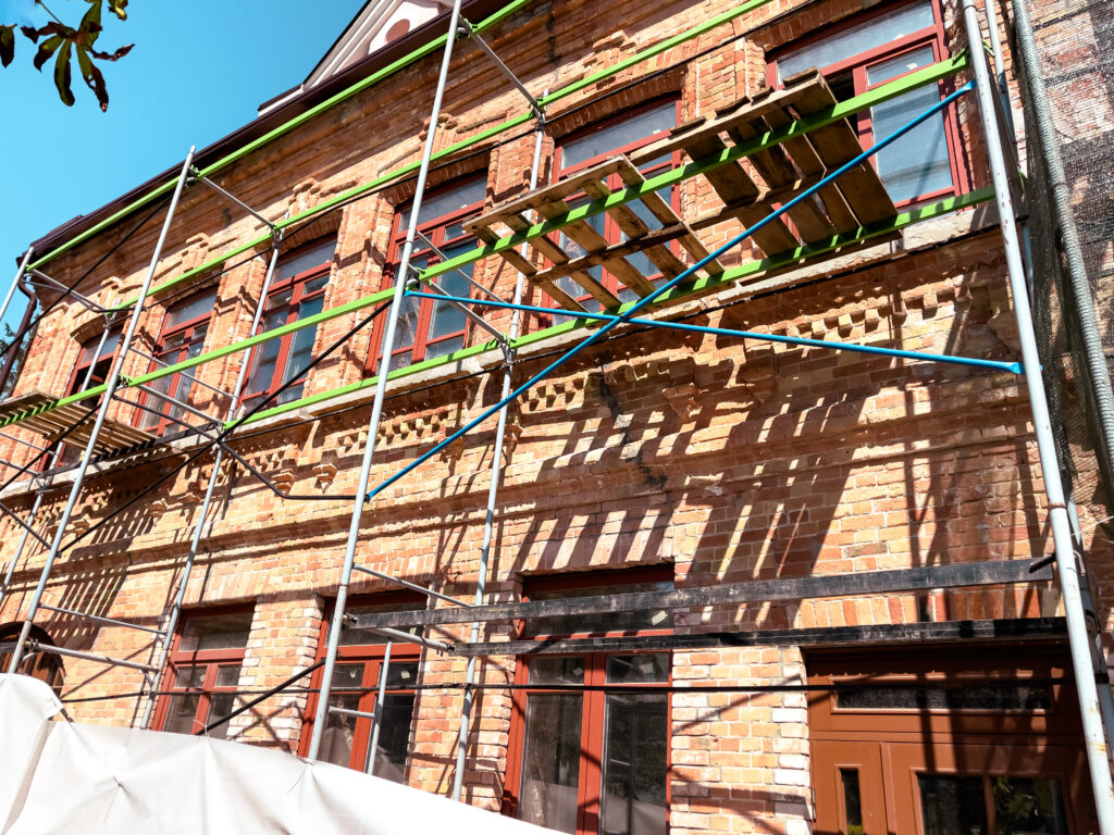 Historical building facade restoration with scaffolding in Queens, NY.